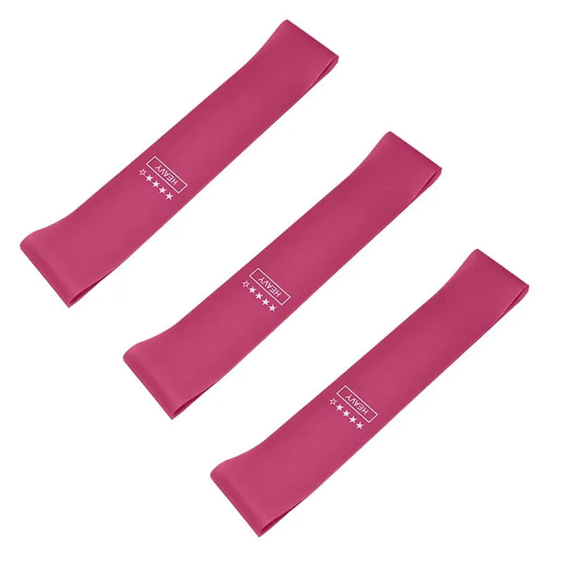 Three pink heavy resistance bands for exercise and physical therapy on white background