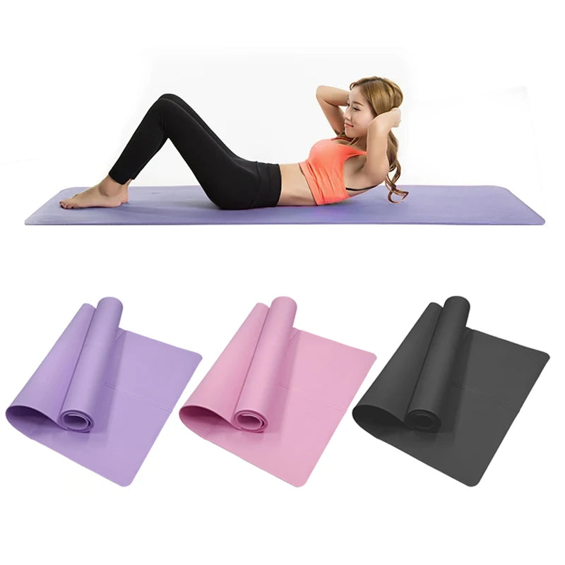 Woman exercising on a purple yoga mat with rolled mats in purple, pink, and black below