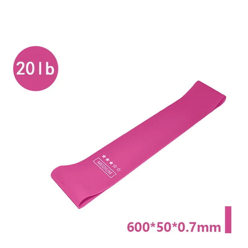 Pink medium resistance loop exercise band, 20 lb, 600x50x0.7mm fitness accessory.