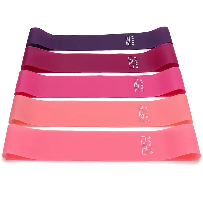 Set of five colorful resistance bands labeled with different strength levels for fitness